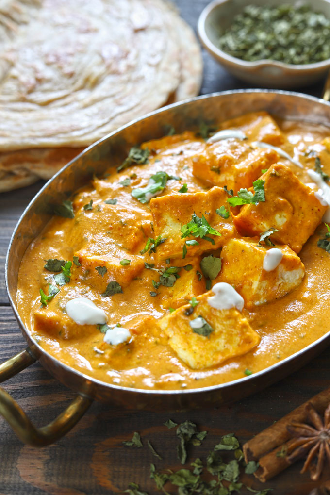 side close up shot of paneer makhani in a copper serveware