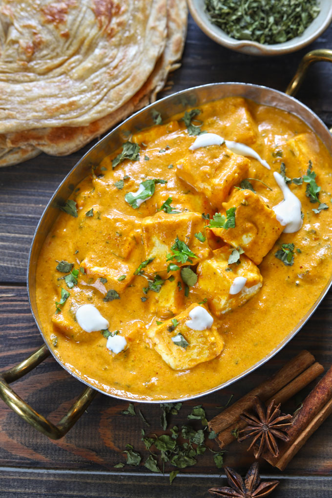 aerial shot of paneer butter masala in a traditional serveware