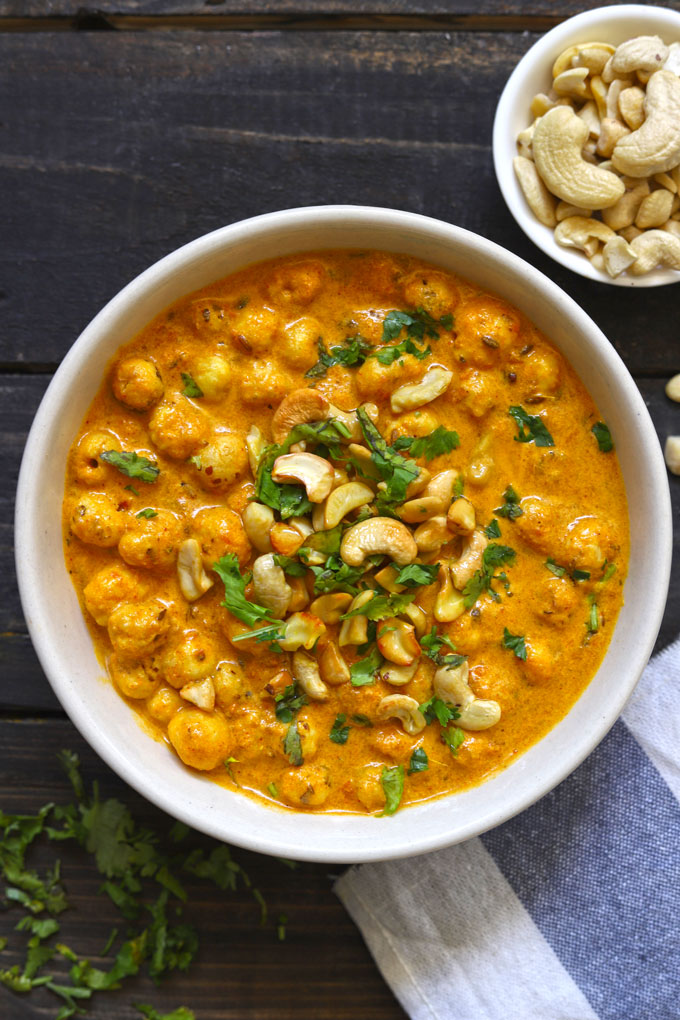 aerial shot of makhana sabzi in a ceramic bowl on a black surface