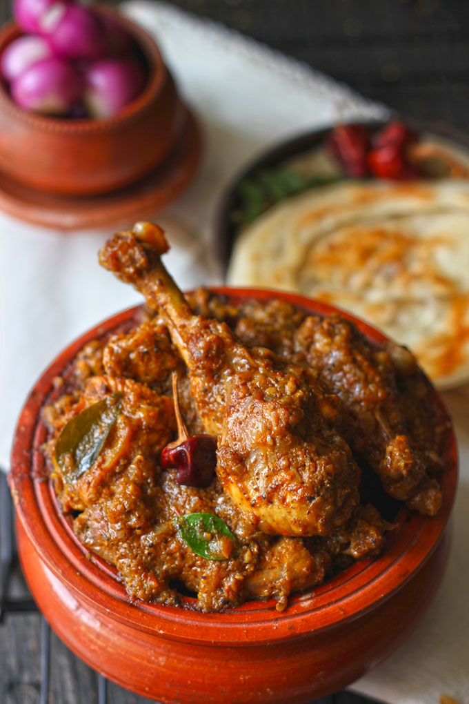 side close up shot of Chettinad chicken masala in a traditional earthen serveware