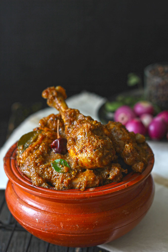 side close up shot of Chettinad chicken masala in a traditional earthen serveware