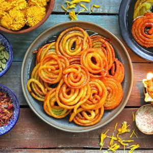 aerial shot of jalebi stacked in a black platter