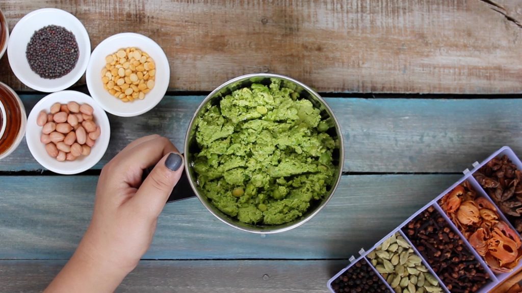 aerial shot of green peas stuffing in a mixer