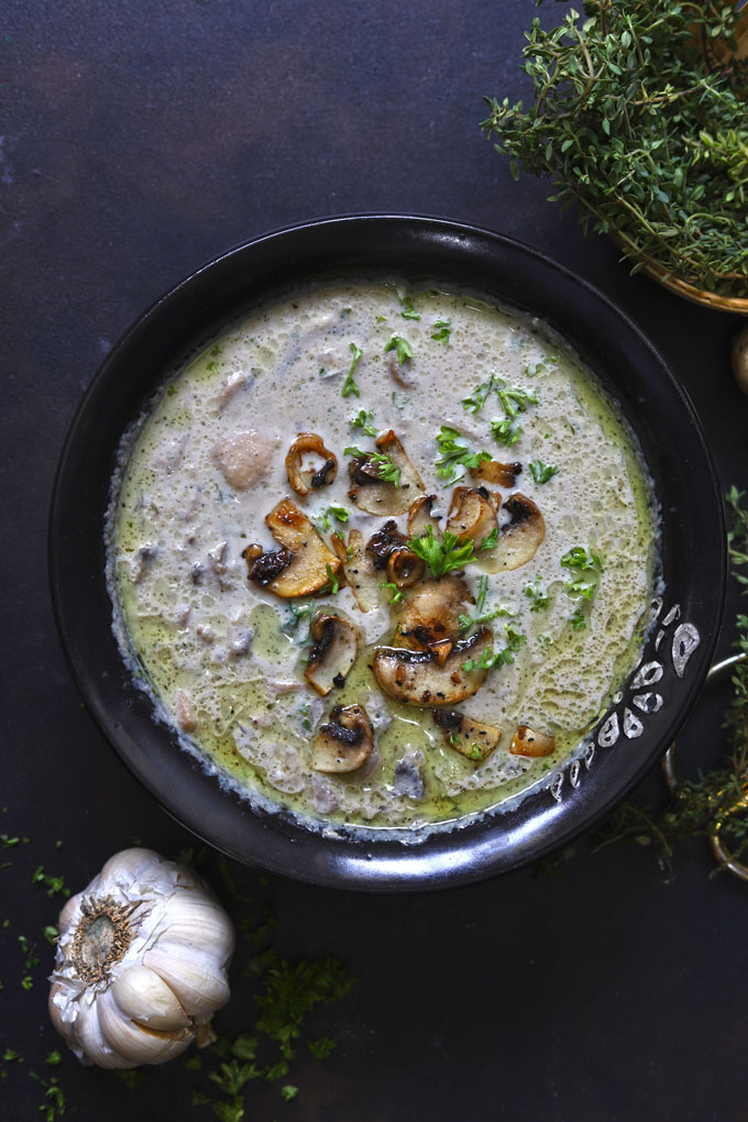 aerial shot of creamy mushroom soup in a black bowl