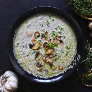 aerial shot of creamy mushroom soup in a black bowl