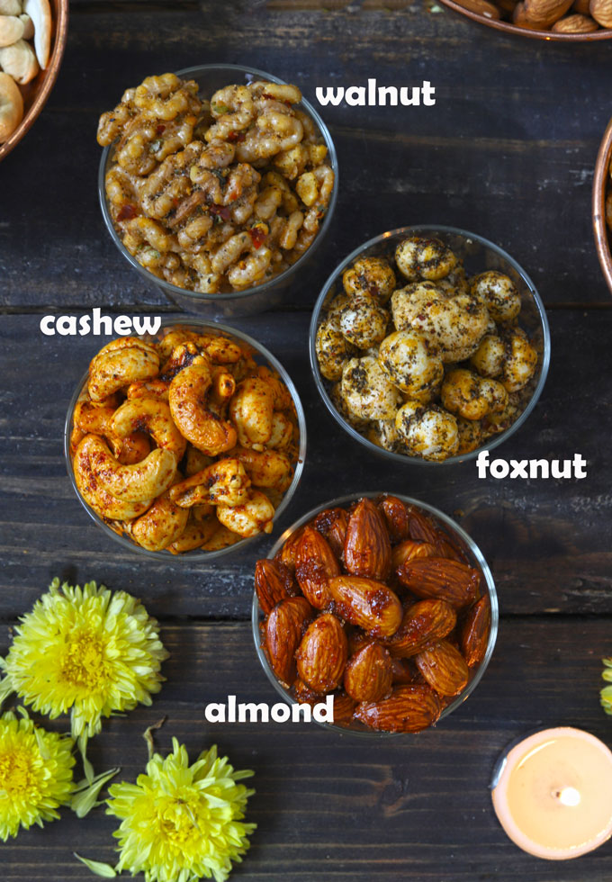 aerial shot of roasted nuts in glass bowls on a black surface