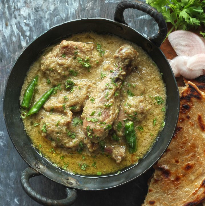 aerial shot of chicken korma masala in a kadhai