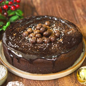 side shot of eggless chocolate cake on a round ceramic plate