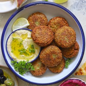 aerial shot of falafel in a white bowl with hummus