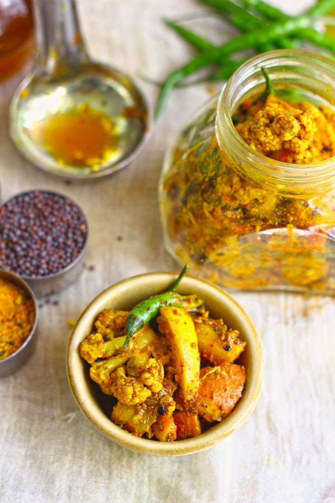 side shot of mixed vegetable pickle in a brown ceramic bowl