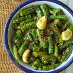 aerial shot of green chilli pickle in a white bowl