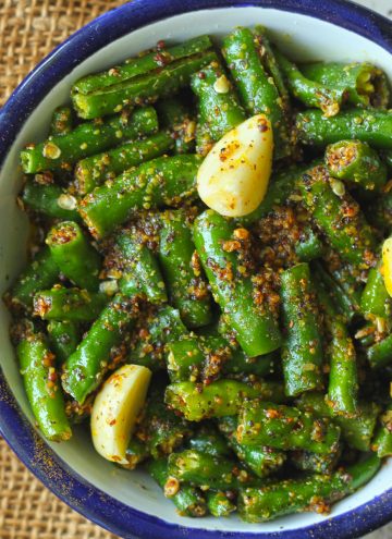 aerial shot of green chilli pickle in a white bowl