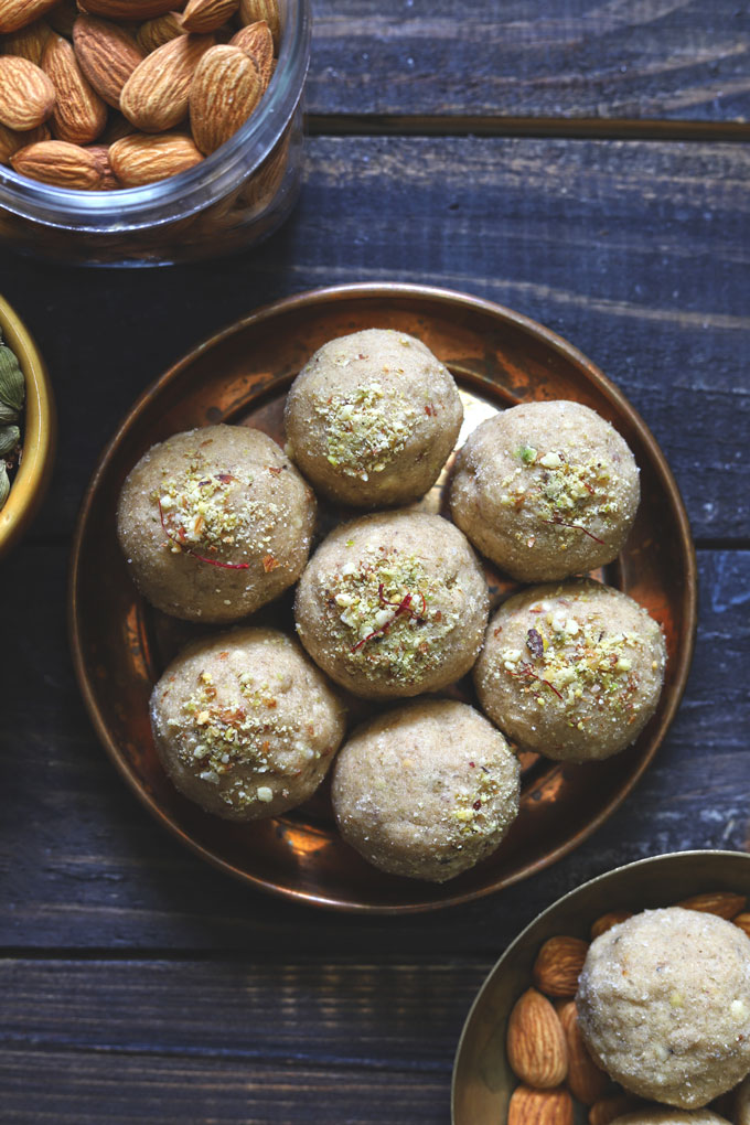 aerial shot of dry fruits wheat ladoo arranged in a copper platter