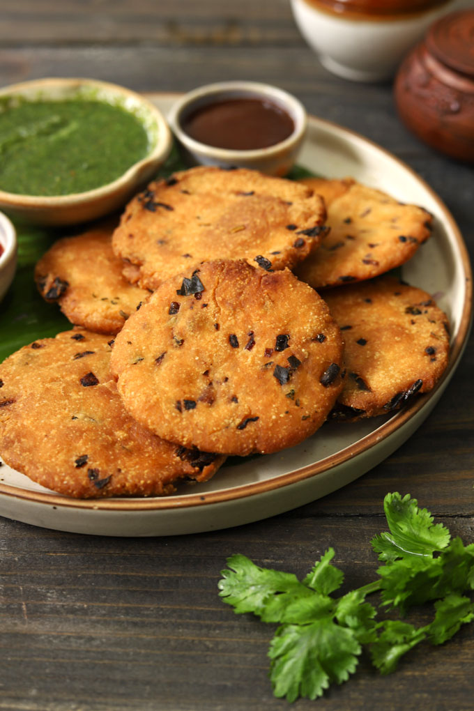 side close up shot of maddur vada stacked on a ceramic plate