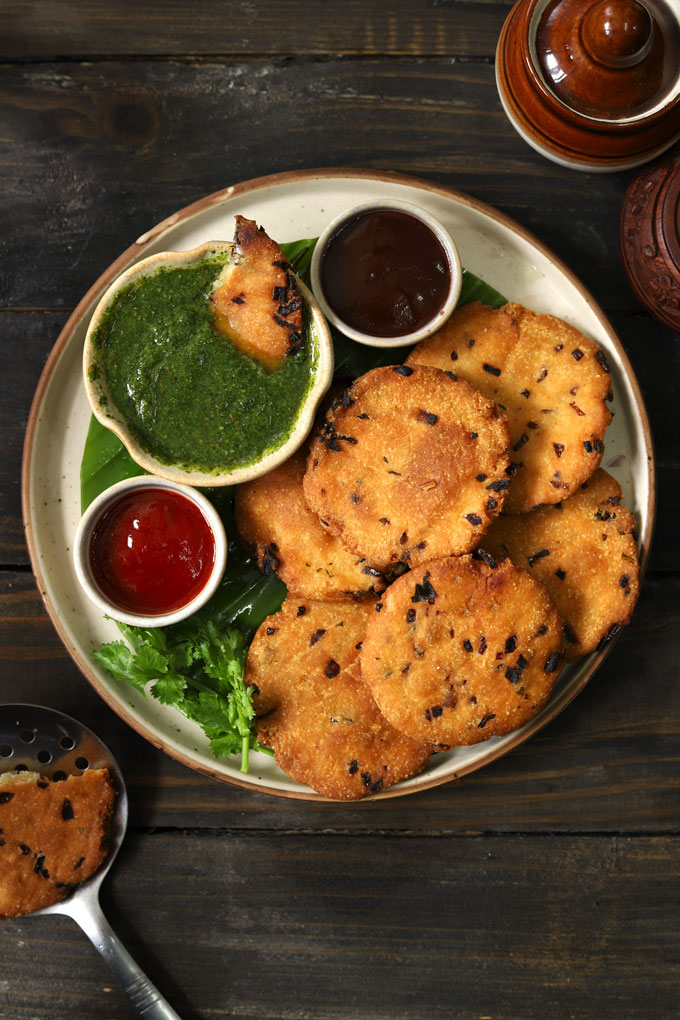 aerial shot of maddur vada with chutney stacked on a round ceramic platter