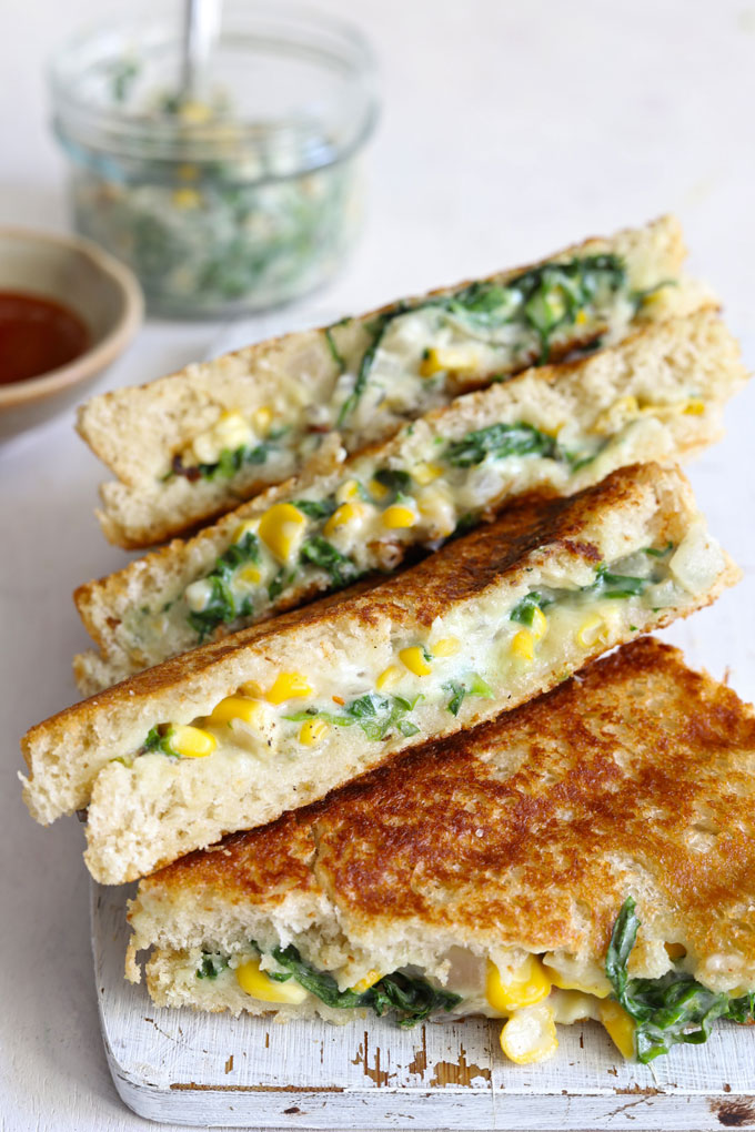 side shot of grilled corn sandwich stacked on a white plate