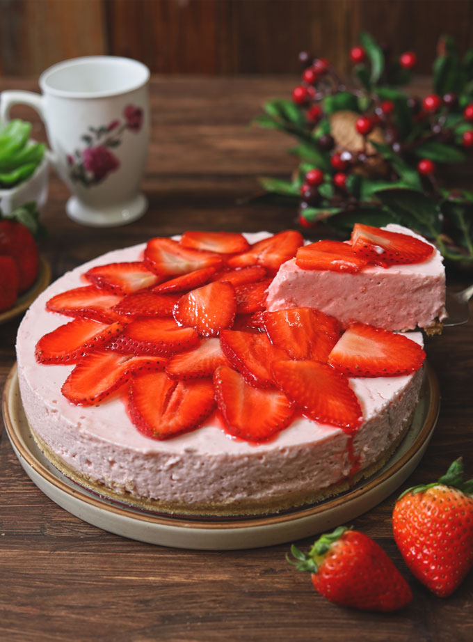 side shot of sliced no bake strawberry cheesecake