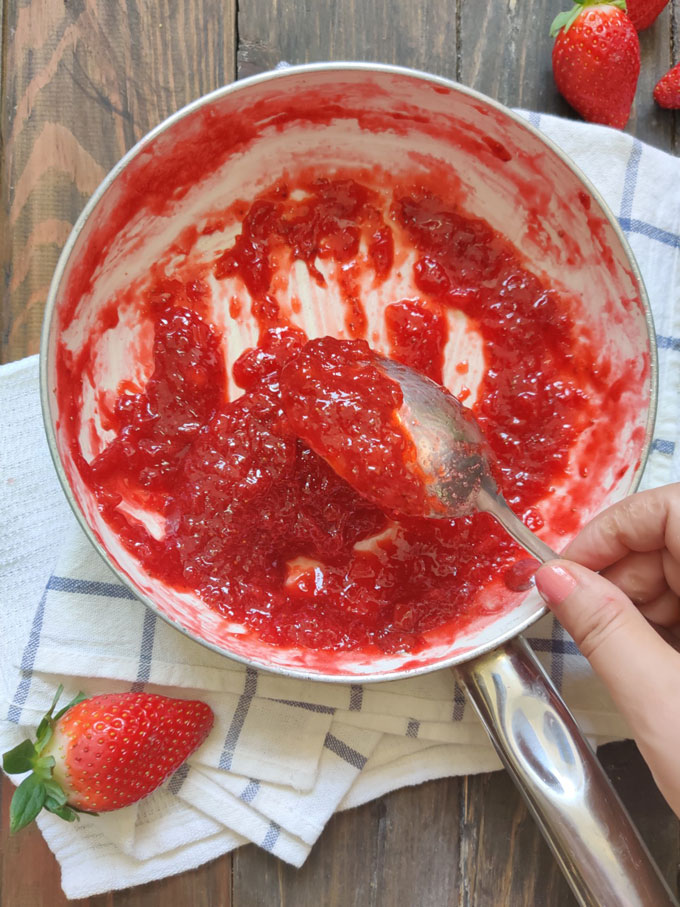 aerial shot of strawberry jam in a white saucepan