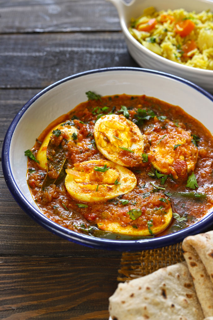 side close up shot of anda curry served on a white platter