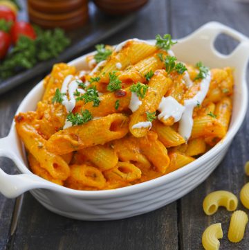 side close up shot of makhani sauce pasta served on a white ceramic dish