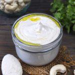 side shot of vegan cashew sauce in a glass jar