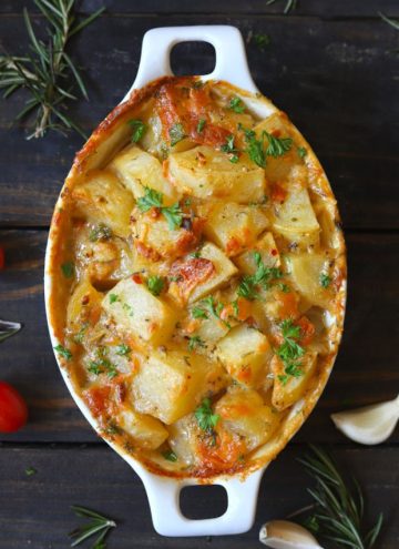 aerial shot of baked potato in a white ceramic baking dish