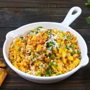 side shot of cheese chilli corn dip in a white pan