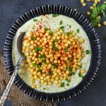 aerial shot of boondi raita in a black ceramic bowl