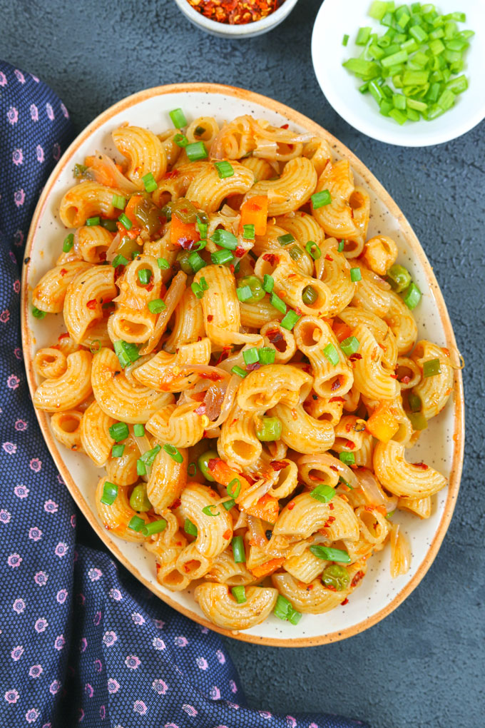 aerial shot of masala macaroni on an oval ceramic platter