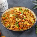 side close up shot of pineapple fried rice in a ceramic bowl