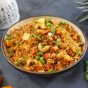 side close up shot of pineapple fried rice in a ceramic bowl