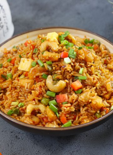 side close up shot of pineapple fried rice in a ceramic bowl
