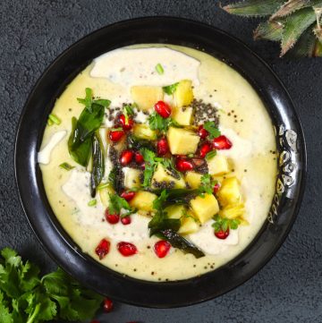 aerial shot of pineapple raita in a black ceramic bowl