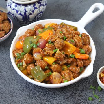 side close up shot of soya manchurian in a white serving platter