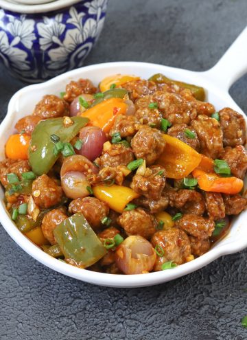 side close up shot of soya manchurian in a white serving platter