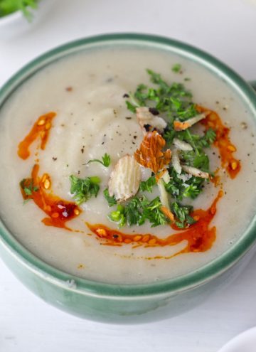 side shot of cauliflower soup in a green ceramic mug