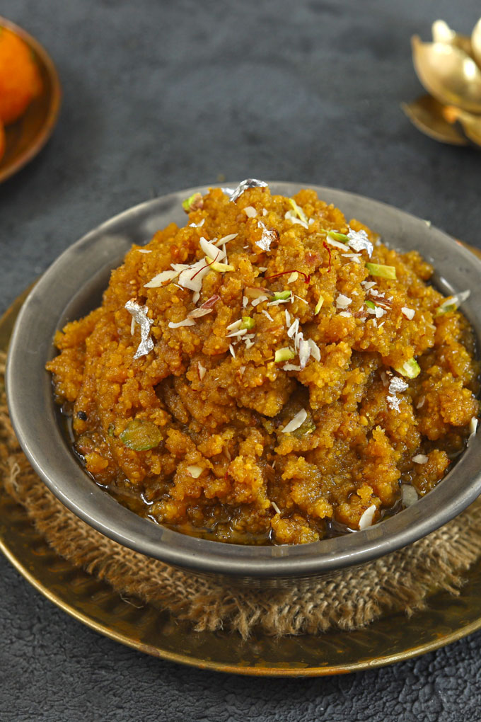 side close up shot of moong dal halwa in a black ceramic bowl