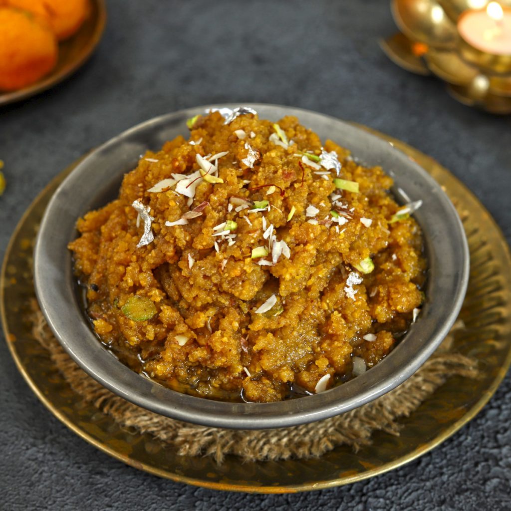 side close up shot of moong dal halwa in a black ceramic bowl - 59
