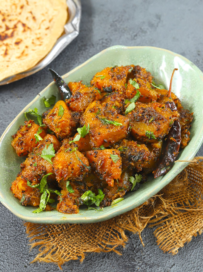 side shot of kaddu ki sabzi in a green ceramic platter