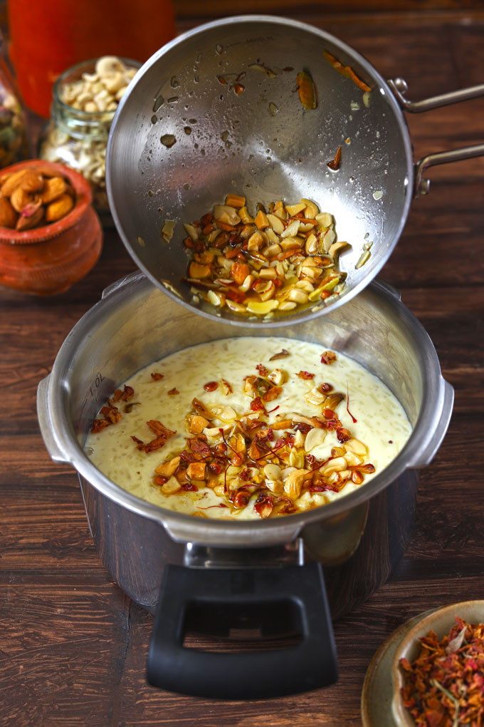 adding ghee fried nuts to chawal ki kheer