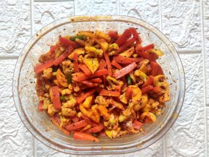 Gobhi Gajar Ka Achar in a glass mixing bowl