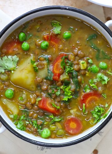 aerial shot of lentil stew in a white ceramic bowl