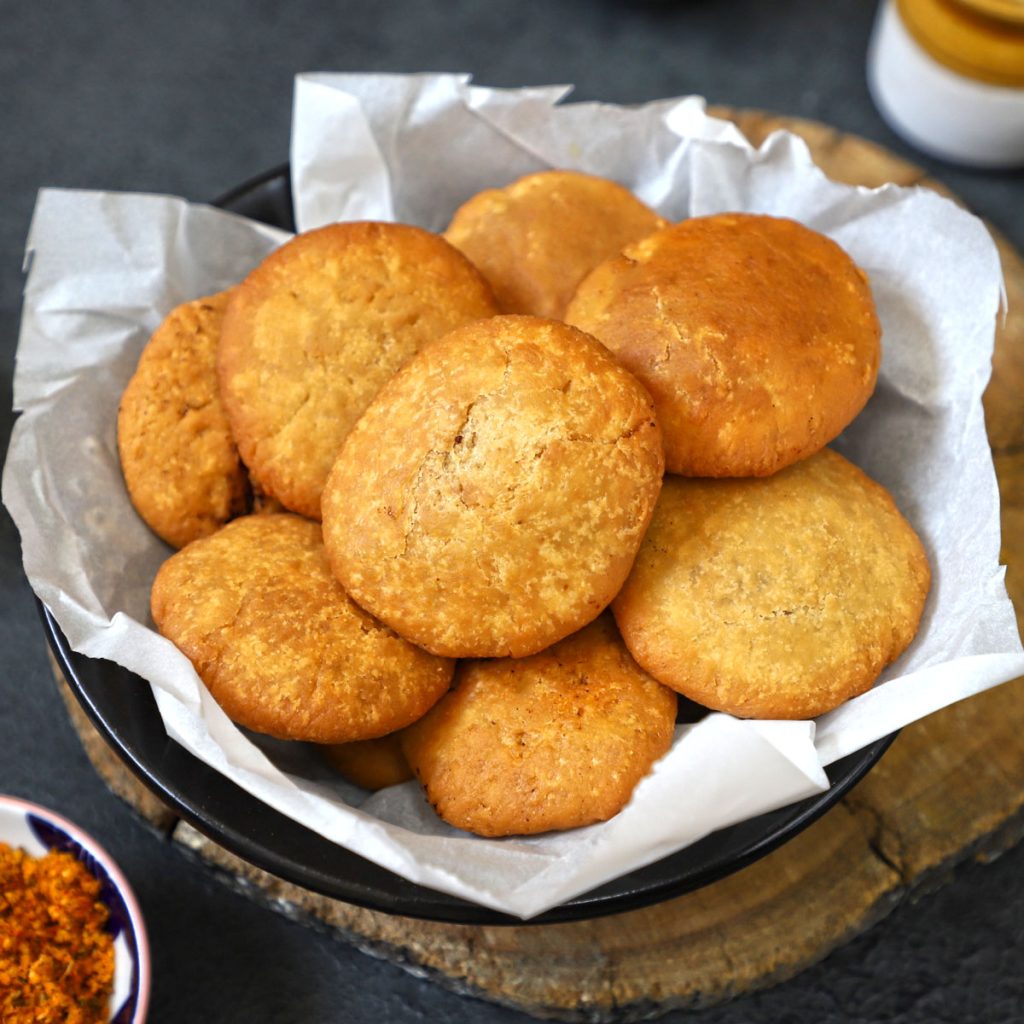 side close up shot of khasta kachori stacked up in a bowl - 14