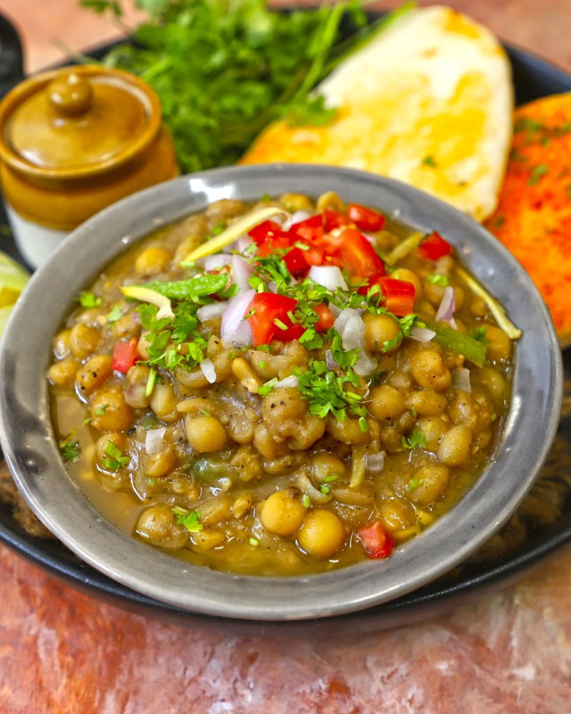 side shot of matar in a black ceramic bowl