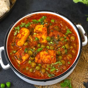 aerial shot of matar paneer in a white bowl