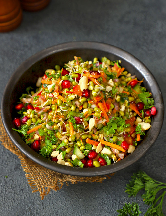 side shot of mung bean sprout salad in a black ceramic bowl