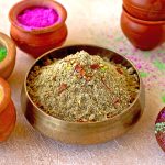 side shot of thandai powder in a brass bowl