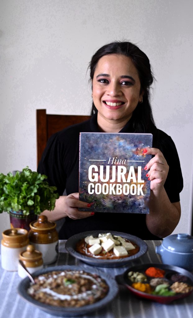 portrait of Hina Gujral with her cookbook