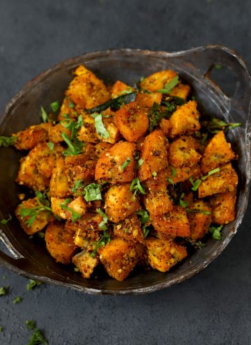 side close up shot of kacche kele ki sabji in a cast iron kadhai