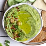 aerial shot of avocado hummus in a white ceramic bowl